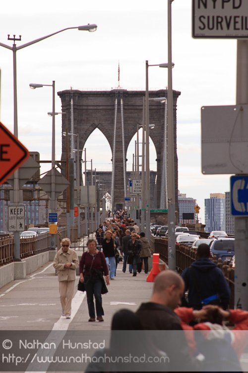 People crowd the Brooklyn Bridge
